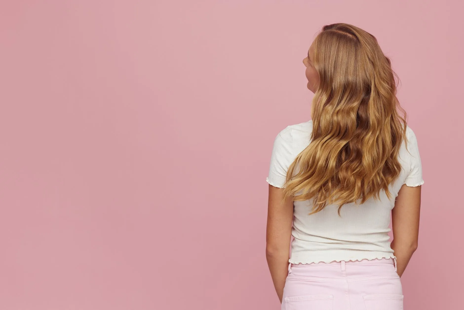 Long blonde wavy hair falling past the shoulders